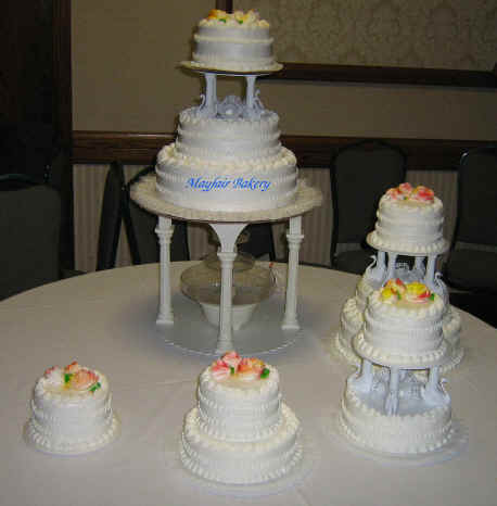 Cascading wedding cake in fall colors and water fountain