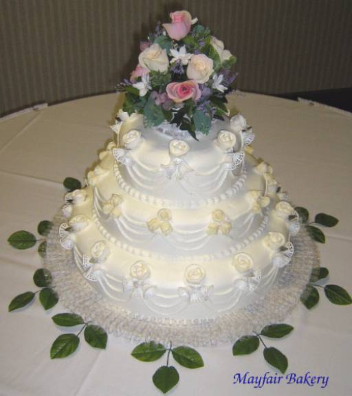 Three tier wedding cake with flower arrangement