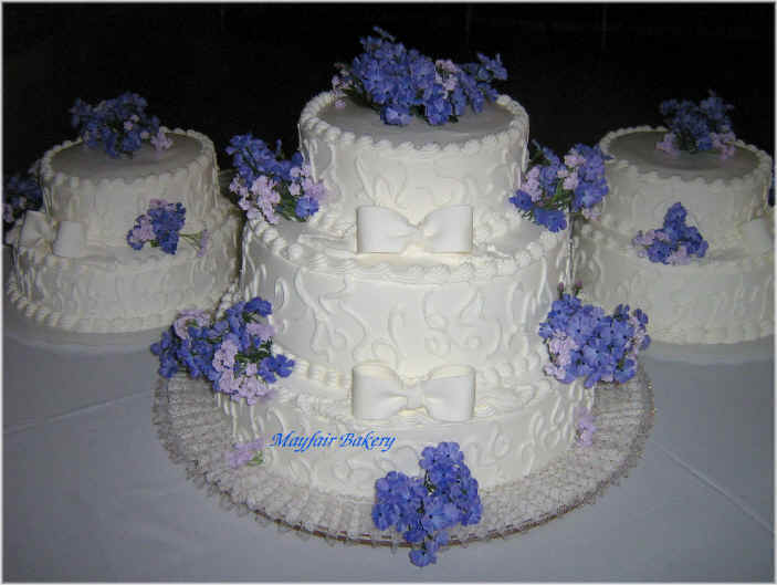 Lavender wedding cakes with fondant bows and craft flowers